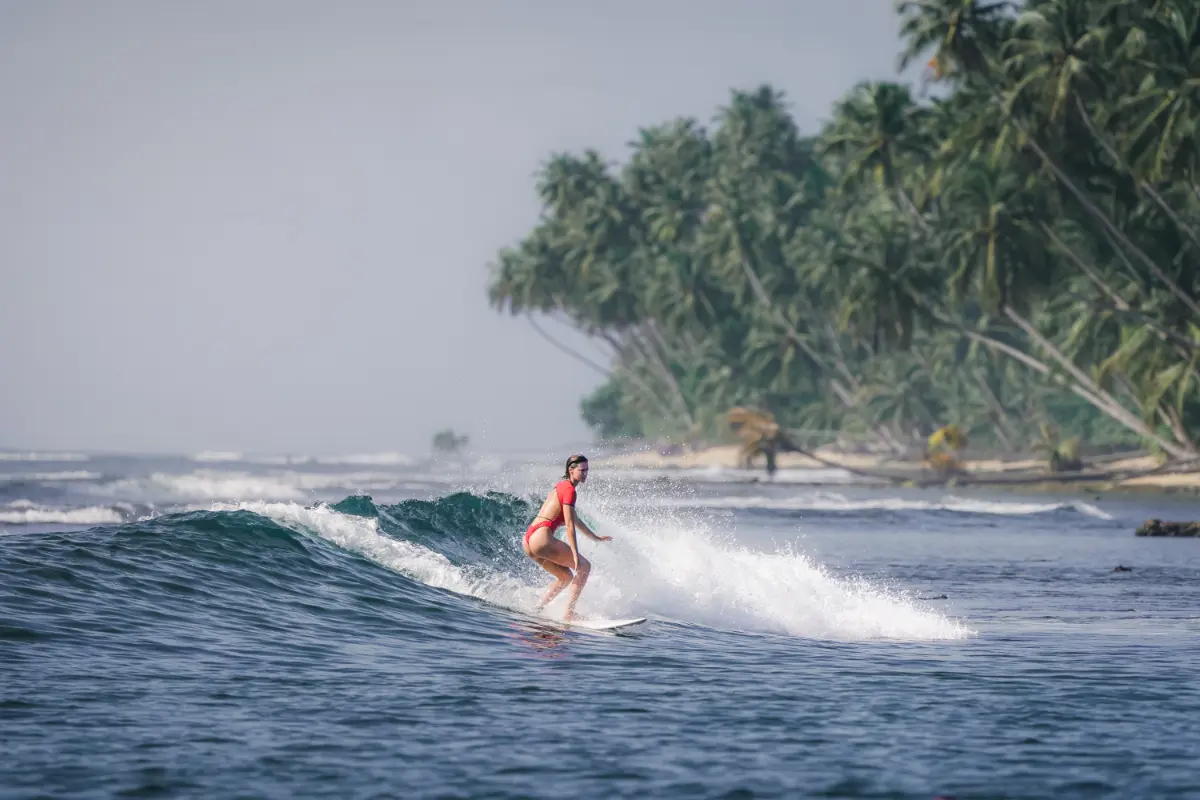 girl surfing on sea waves