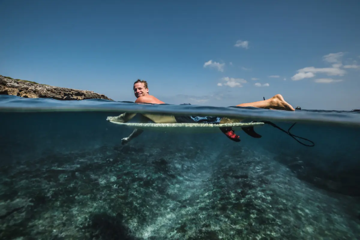 surfer lies on surfboard
