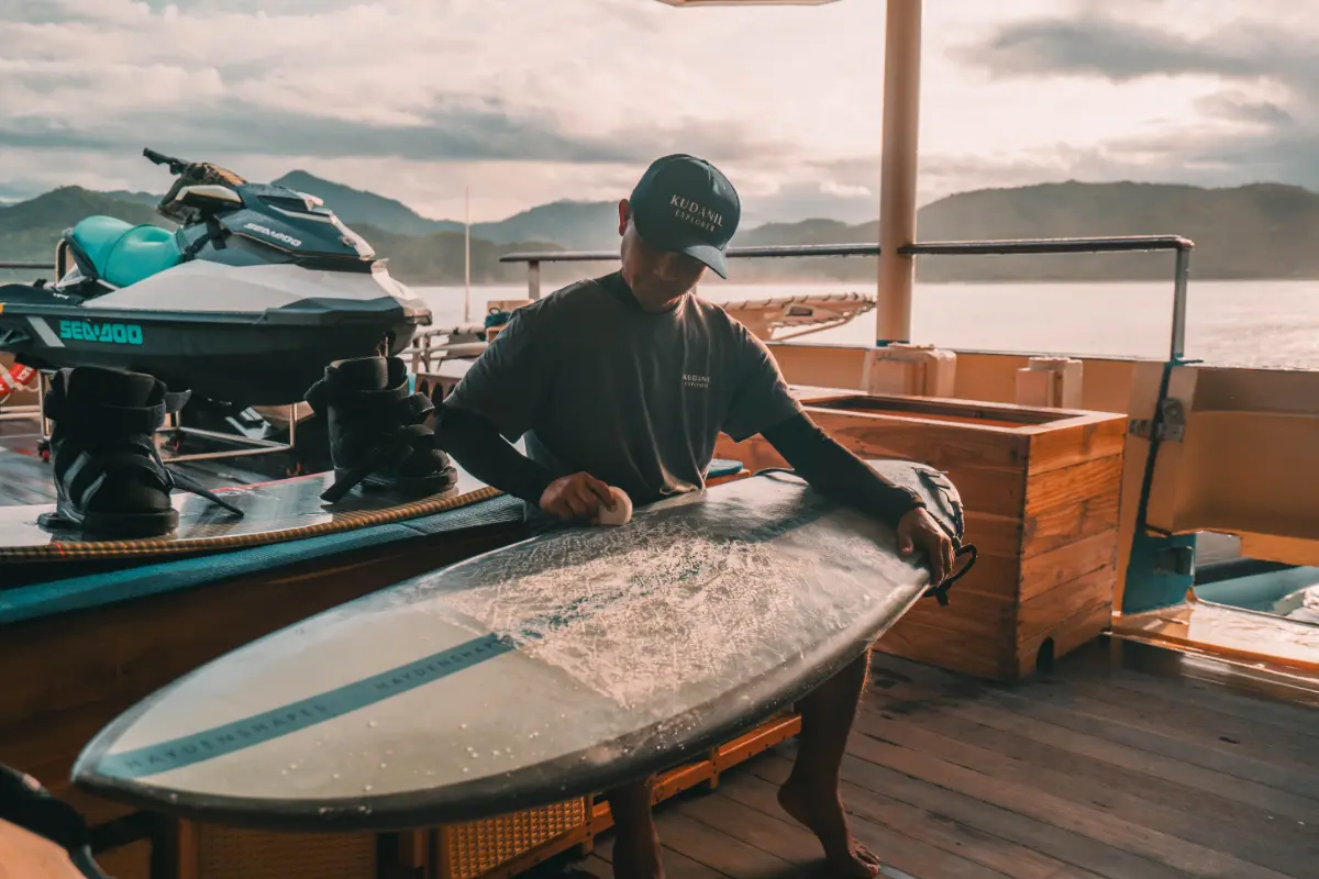 guy polishing surf board